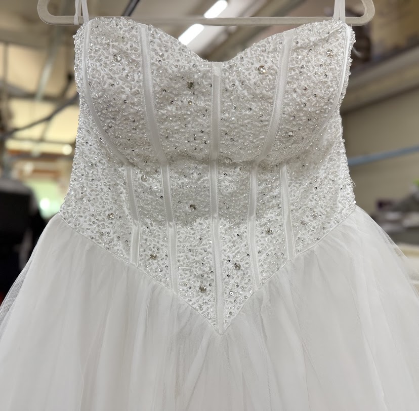 A white suit with stubborn stains brought in for restoration