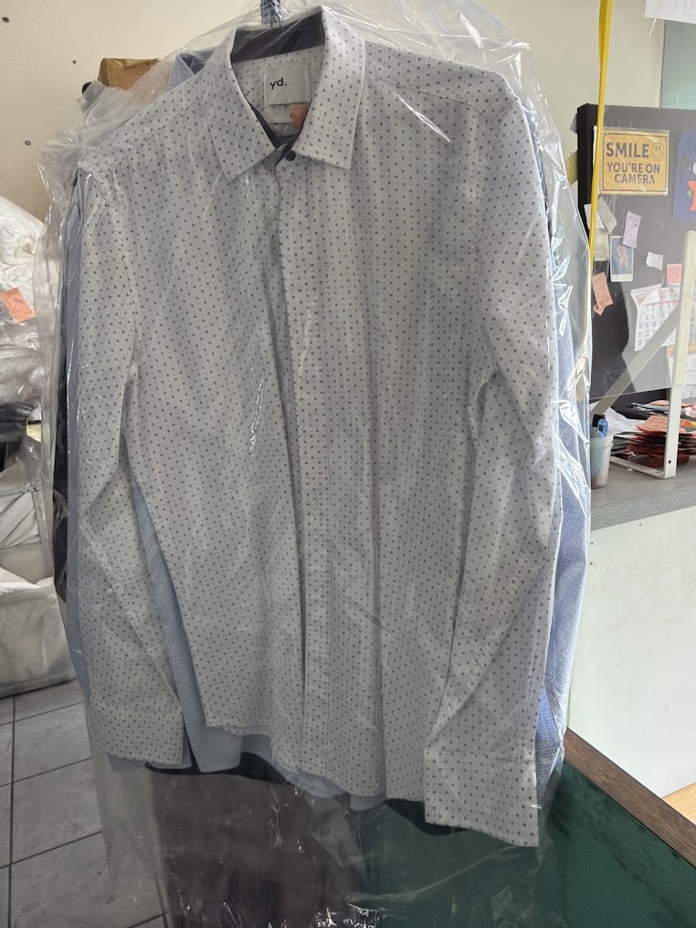 A white suit with stubborn stains brought in for restoration